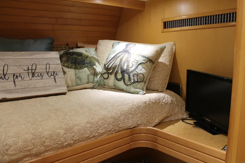 Slide: The Image of Cozy cabin interior of 1997 McKinna 48 Pilothouse with decorative pillows and small TV. - 28