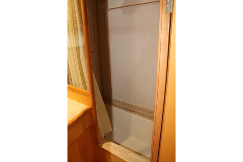 Slide: The Image of 1997 McKinna 48 Pilothouse interior closet with wooden finish. - 41