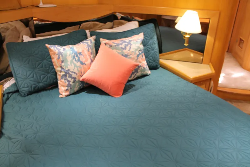 Slide: The Image of Luxurious bedroom interior of 1997 McKinna 48 Pilothouse yacht with teal bedding and decorative pillows. - 39