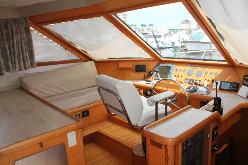 Slide: The Image of Interior of a 1997 McKinna 48 Pilothouse yacht with helm and seating area. - 18