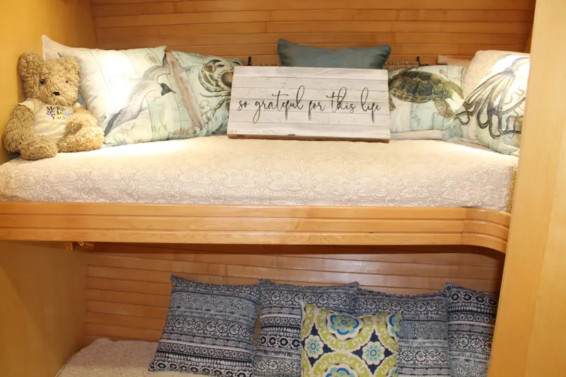 Slide: The Image of Cozy bunk beds in 1997 McKinna 48 Pilothouse with decorative pillows and teddy bear. - 29