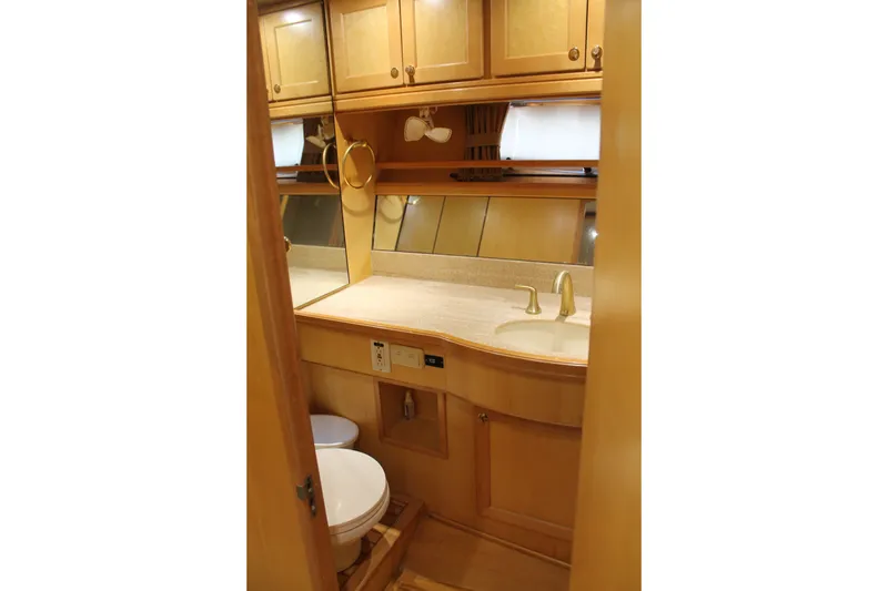 Slide: The Image of Bathroom interior of 1997 McKinna 48 Pilothouse yacht with wooden cabinetry and modern fixtures. - 40