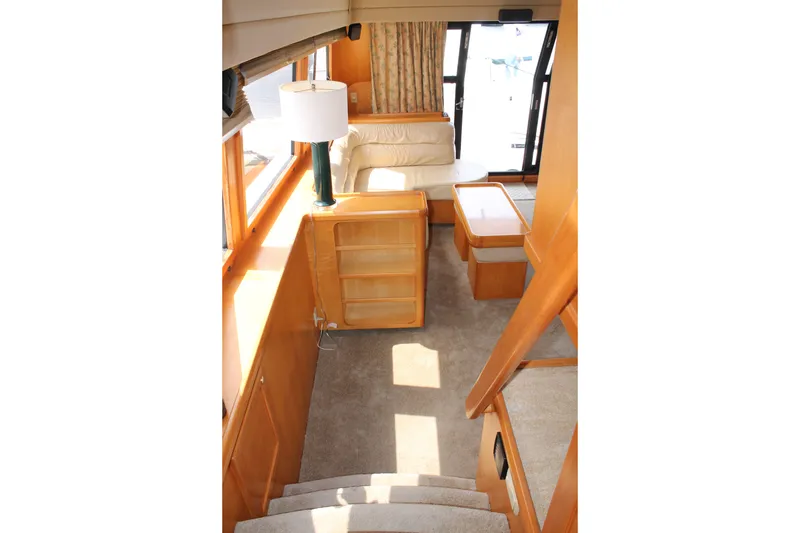 Slide: The Image of Interior of 1997 McKinna 48 Pilothouse yacht with cozy seating and wooden furnishings. - 13