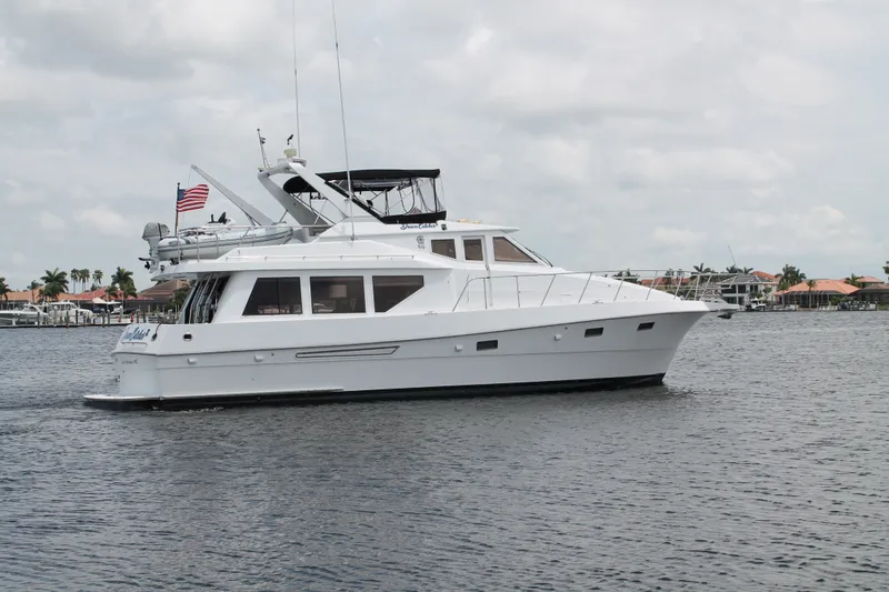 The Image of 1997 McKinna 48 Pilothouse yacht cruising on a calm waterway. - 0