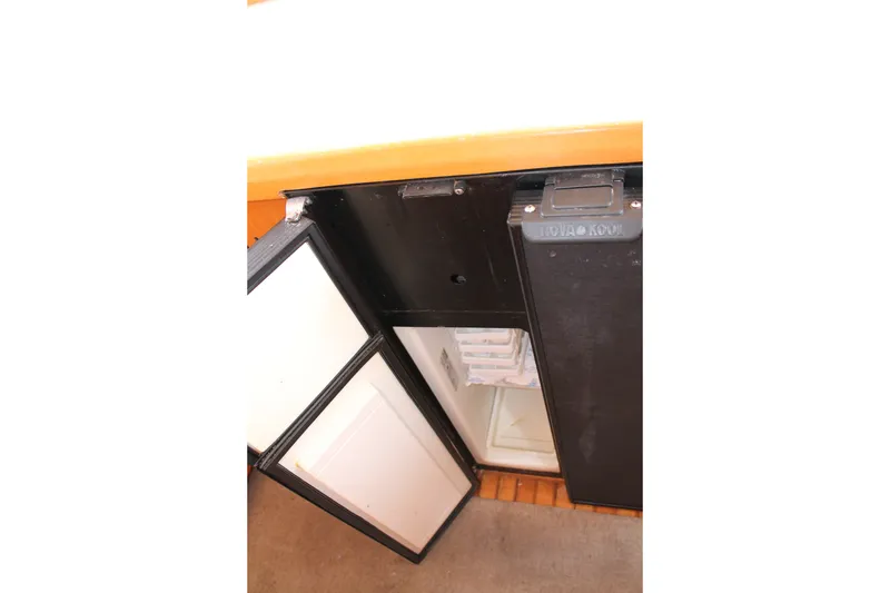 Slide: The Image of Open refrigerator on 1997 McKinna 48 Pilothouse yacht, showcasing interior storage space. - 35