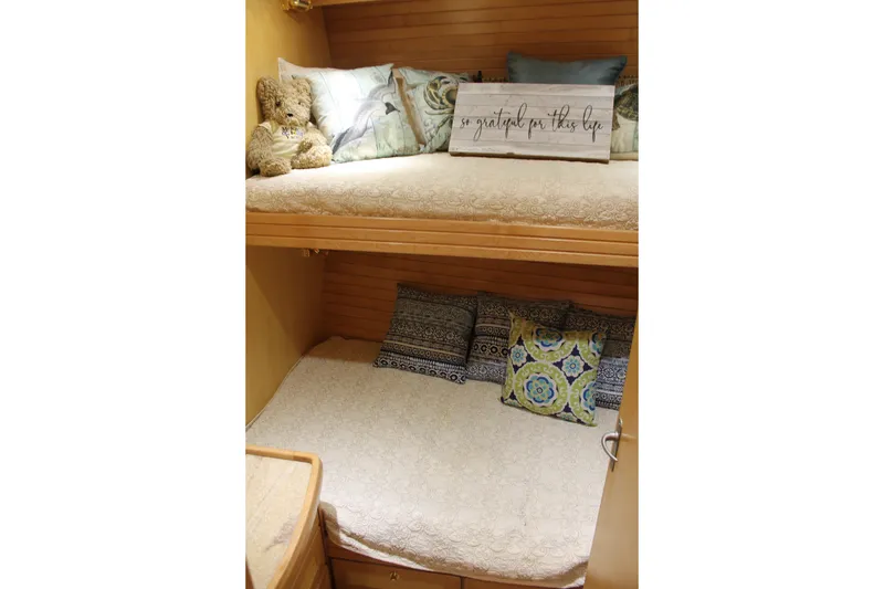 Slide: The Image of Cozy bunk beds with decorative pillows in a 1997 McKinna 48 Pilothouse yacht. - 27