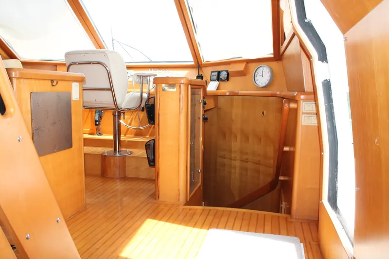 Slide: The Image of Interior of 1997 McKinna 48 Pilothouse with wooden finish and captain's chair. - 20