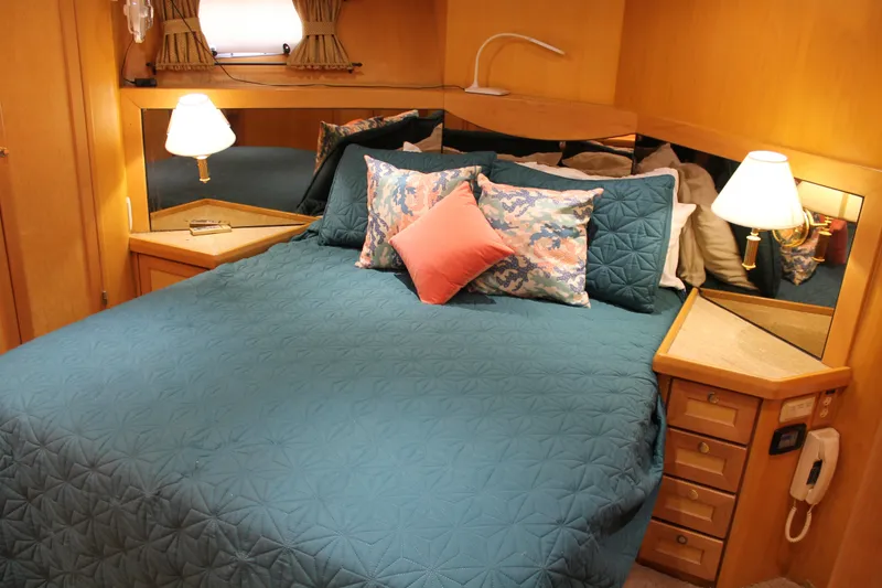 Slide: The Image of Cozy bedroom in 1997 McKinna 48 Pilothouse with teal bedding and decorative pillows. - 36