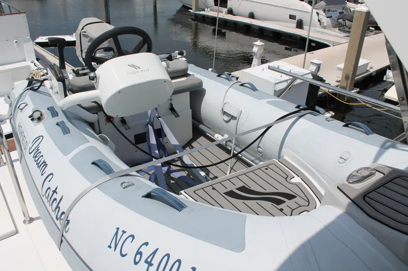 Slide: The Image of Inflatable boat on McKinna 48 Pilothouse, 1997 model, docked at marina. - 50