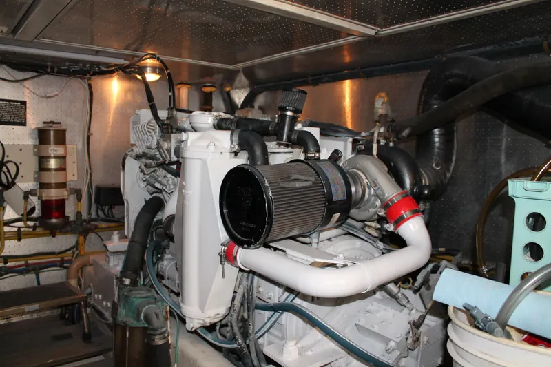 Slide: The Image of Engine room of a 1997 McKinna 48 Pilothouse yacht, showcasing mechanical components. - 59