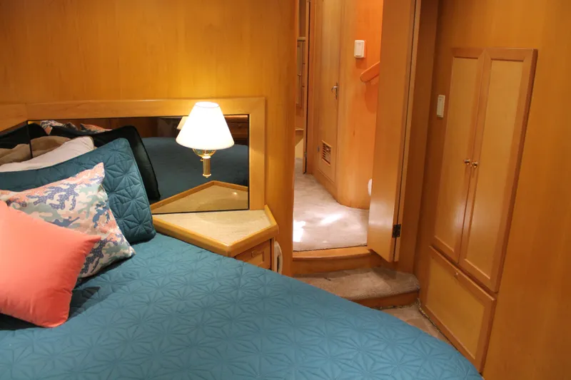 Slide: The Image of Cozy bedroom in 1997 McKinna 48 Pilothouse yacht with elegant wood paneling and soft lighting. - 38