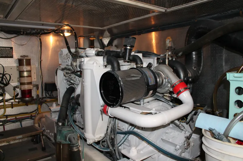 Slide: The Image of Engine room of a 1997 McKinna 48 Pilothouse yacht, showcasing mechanical components. - 58