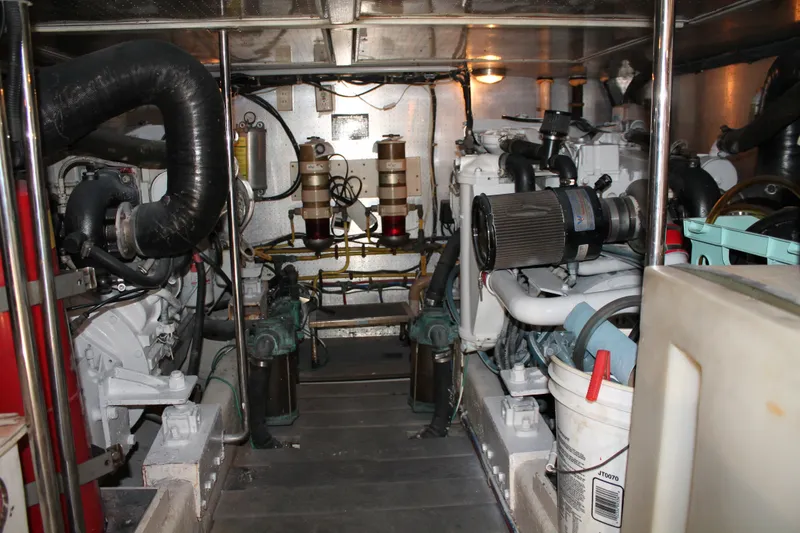 Slide: The Image of Engine room of a 1997 McKinna 48 Pilothouse yacht, showcasing mechanical components. - 64