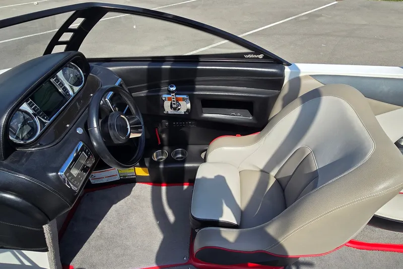 Slide: The Image of 2011 Malibu Wakesetter 247 LSV interior with steering wheel and dashboard controls. - 14