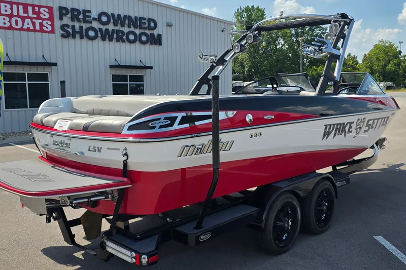 Slide: The Image of 2011 Malibu Wakesetter 247 LSV boat at pre-owned showroom, red and white design. - 6
