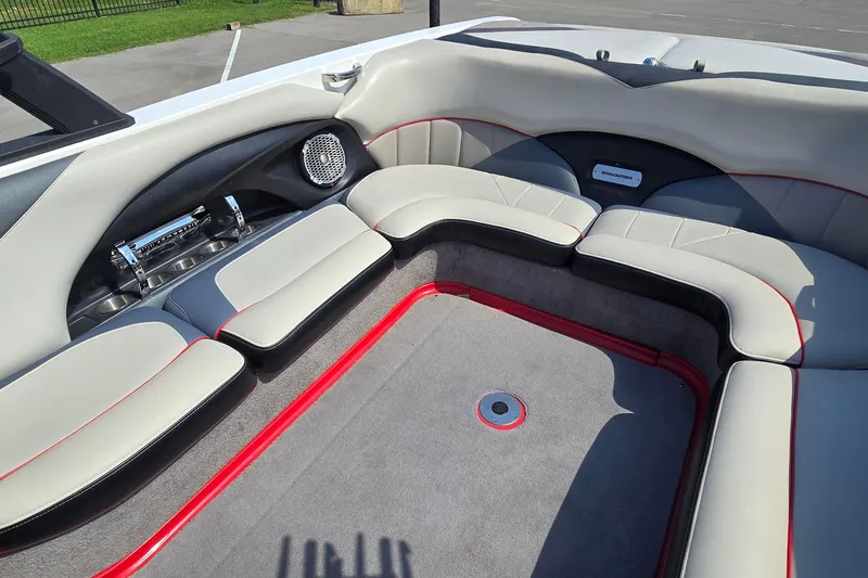 Slide: The Image of Interior of 2011 Malibu Wakesetter 247 LSV boat with cushioned seating and speaker system. - 10