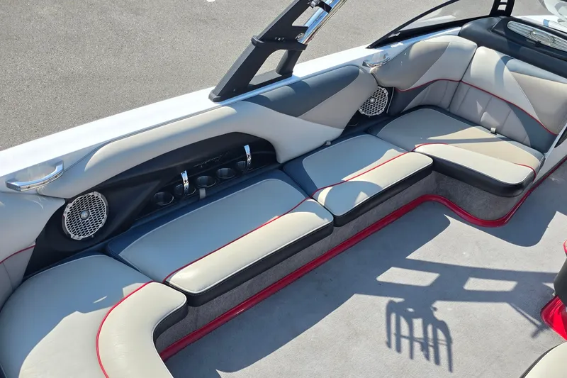 Slide: The Image of 2011 Malibu Wakesetter 247 LSV interior with gray seating and red accents. - 12