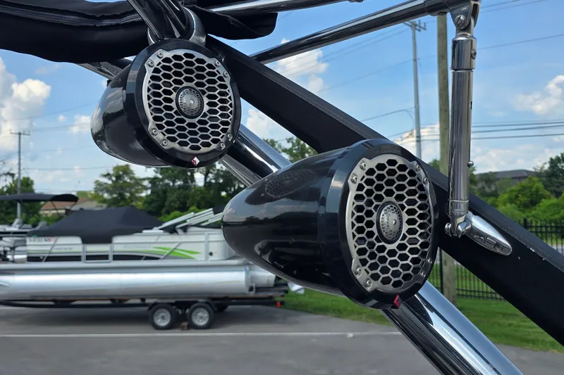 Slide: The Image of Speakers on a 2011 Malibu Wakesetter 247 LSV boat, with a pontoon in the background. - 18