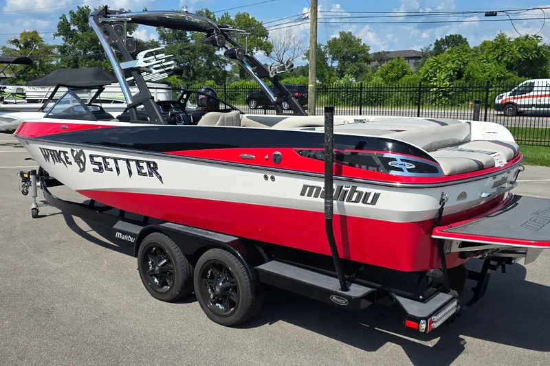 Slide: The Image of 2011 Malibu Wakesetter 247 LSV boat in red and white on a trailer. - 3