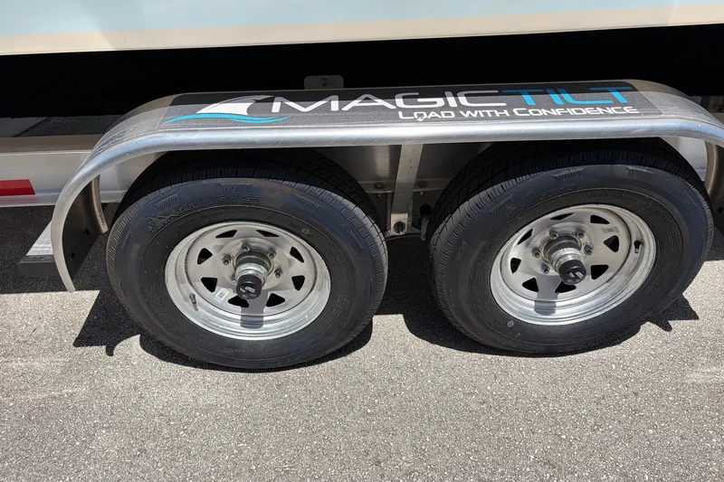 Slide: The Image of Trailer wheels of a 2025 Grady-White Freedom 275 boat on Magic Tilt trailer. - 15