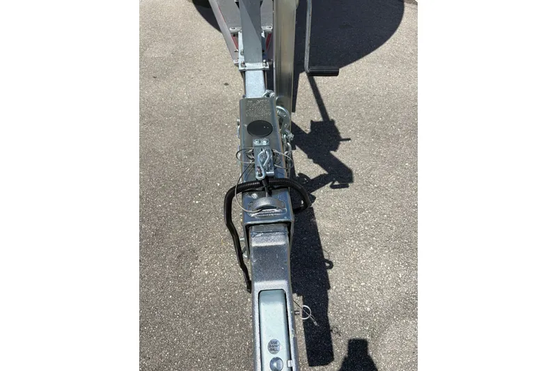 Slide: The Image of Trailer hitch of a 2025 Grady-White Freedom 275 boat on asphalt surface. - 16