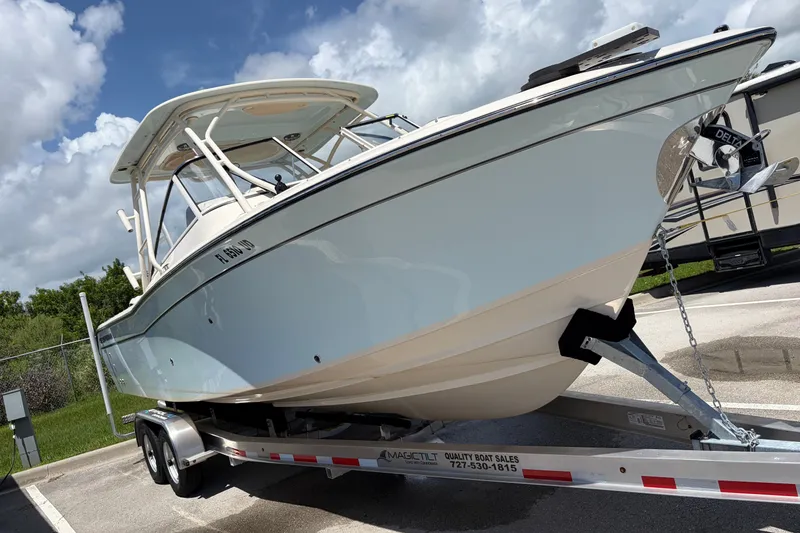 Slide: The Image of 2025 Grady-White Freedom 275 boat on trailer under blue sky. - 4