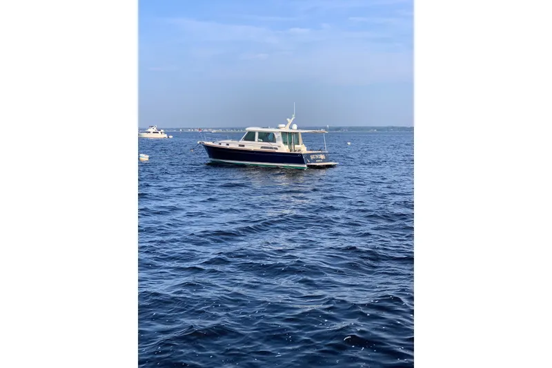 Slide: The Image of 2012 Sabre 42 Salon Express yacht cruising on open blue waters. - 32