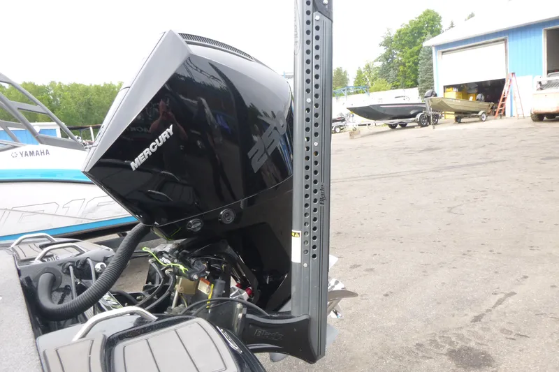 Slide: The Image of Outboard motor on a Phoenix 920 Elite 2025 boat, parked near a blue building. - 17