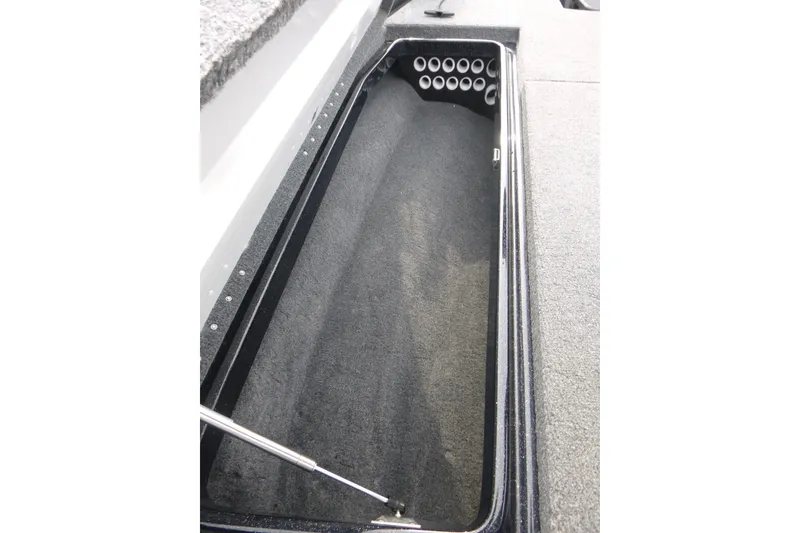 Slide: The Image of Storage compartment of 2025 Phoenix 920 Elite boat, featuring organized rod holders. - 14