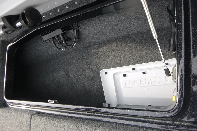 Slide: The Image of Storage compartment in a 2025 Phoenix 920 Elite boat, featuring organized wiring and hydraulic support. - 15