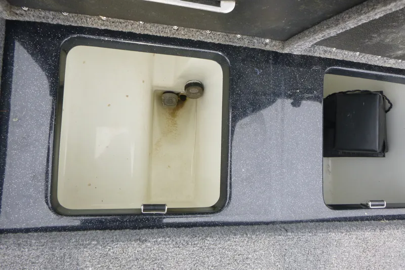Slide: The Image of Storage compartments in a 2025 Phoenix 920 Elite boat, featuring a clean, organized interior. - 16