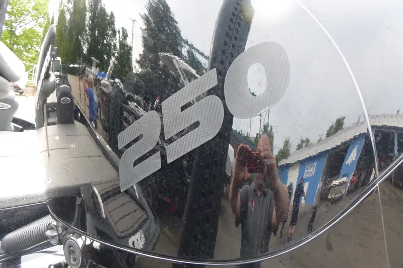 Slide: The Image of 2025 Phoenix 920 Elite boat with "250" decal, reflecting surroundings. - 18