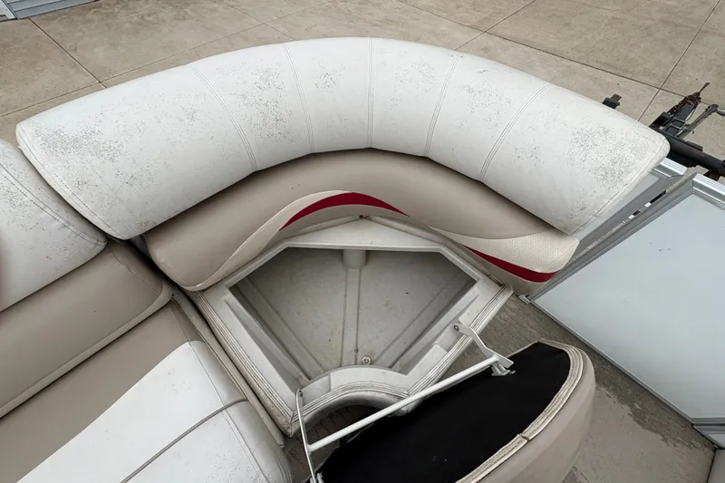 Slide: The Image of 2008 Crest 20 II boat seat with storage compartment, showing wear and tear. - 16