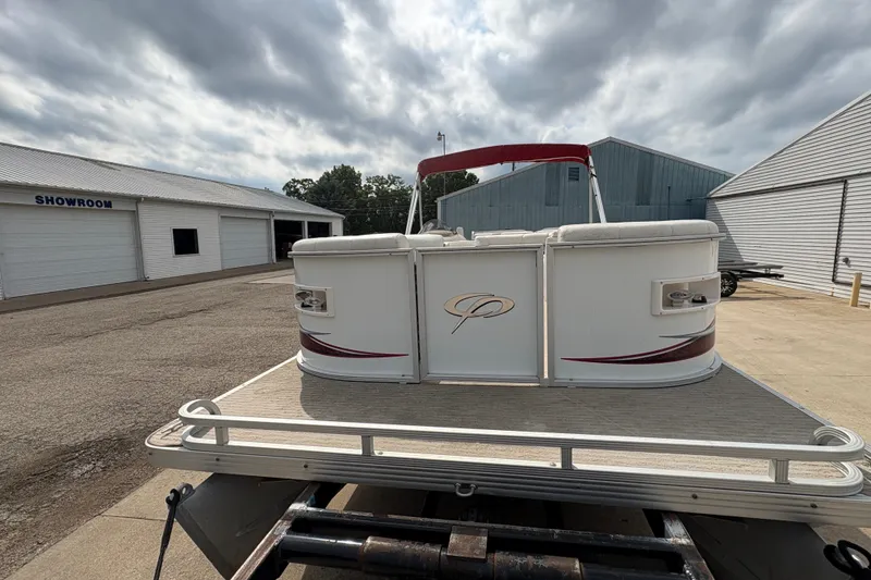 Slide: The Image of 2008 Crest 20 II pontoon boat parked outside a showroom under cloudy skies. - 8