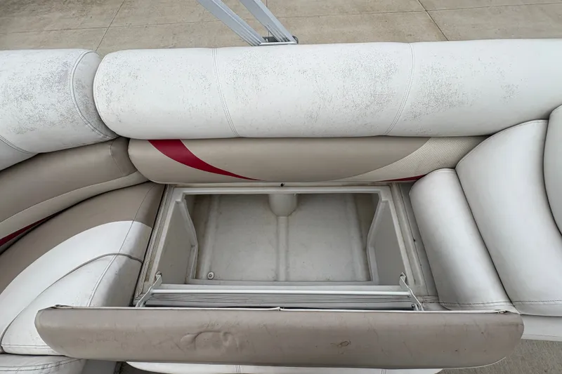 Slide: The Image of Crest 20 II 2008 boat seat storage compartment, open and empty, with white and beige upholstery. - 21