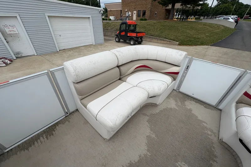 Slide: The Image of White and beige seating on a 2008 Crest 20 II pontoon boat, parked near a garage. - 14