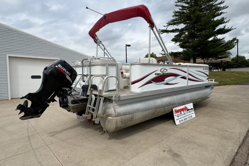 Slide: The Image of 2008 Crest 20 II pontoon boat with Suzuki motor, parked on concrete driveway. - 3