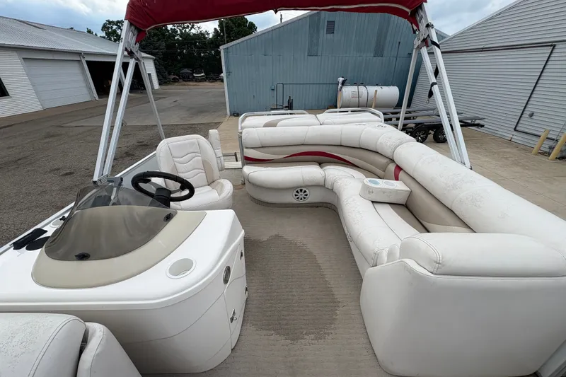 Slide: The Image of 2008 Crest 20 II pontoon boat with white seating and red canopy in a marina setting. - 17