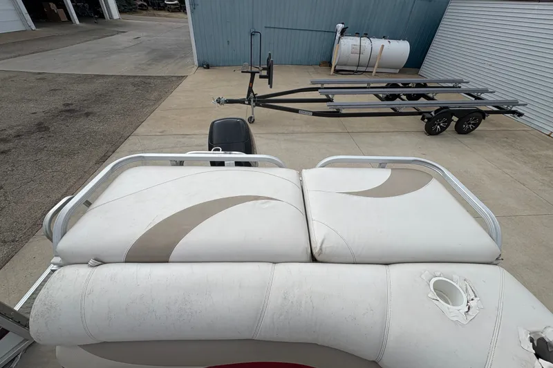 Slide: The Image of 2008 Crest 20 II pontoon boat with trailer in a storage area. - 25
