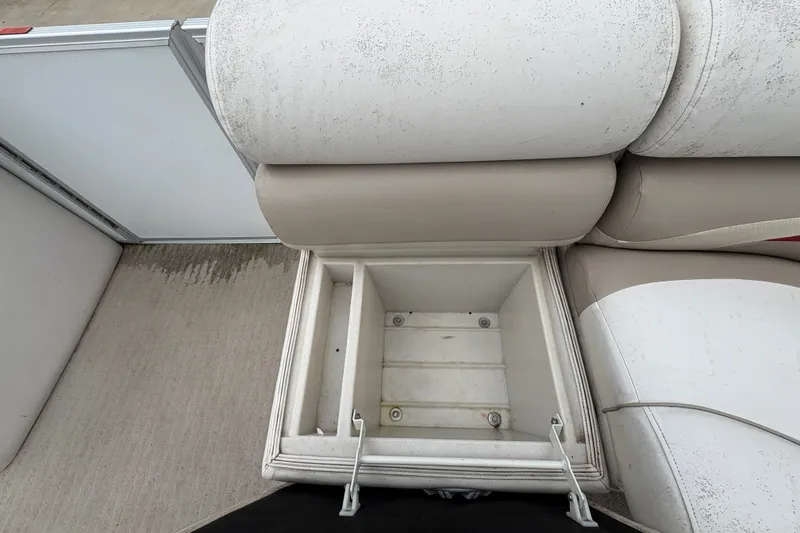 Slide: The Image of Open storage compartment on a 2008 Crest 20 II boat with cushioned seating. - 15