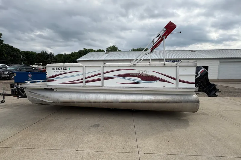 Slide: The Image of 2008 Crest 20 II pontoon boat with red accents, parked outdoors on concrete. - 6