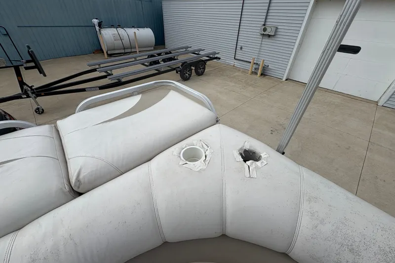 Slide: The Image of Damaged seating on a 2008 Crest 20 II boat, showing torn upholstery and exposed foam. - 24