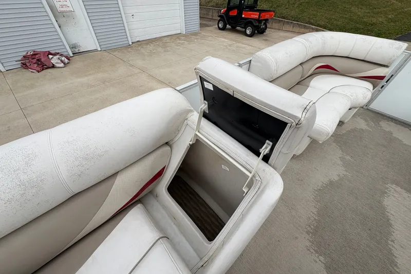 Slide: The Image of Open storage compartment on a 2008 Crest 20 II boat with white seating. - 20