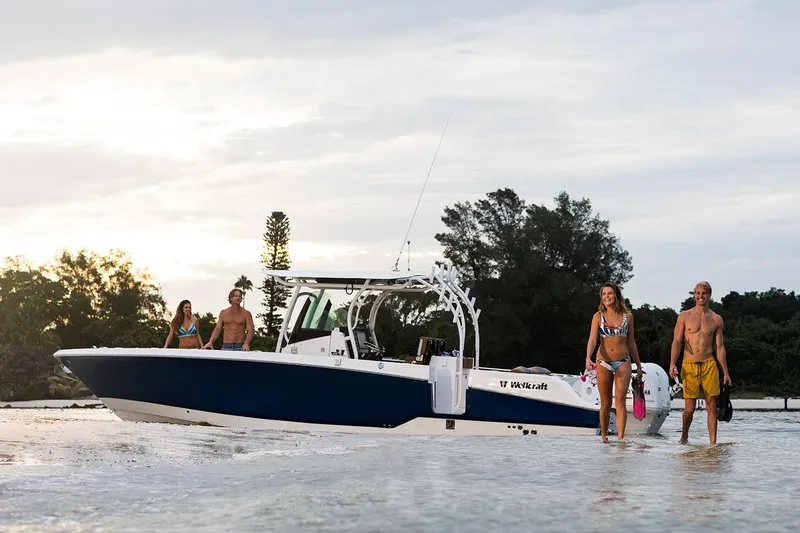 Slide: The Image of Manufacturer Provided Image: 2026 Wellcraft 302 Fisherman boat with people enjoying a day at the beach. - 0