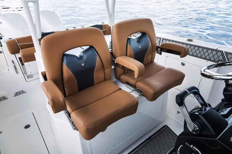 Slide: The Image of Manufacturer Provided Image: Luxurious seating on 2026 Wellcraft 302 Fisherman boat, featuring tan and black leather upholstery. - 8