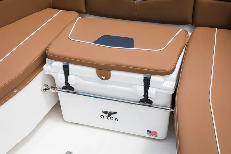 Slide: The Image of Manufacturer Provided Image: 2026 Wellcraft 302 Fisherman boat interior with Orca cooler and cushioned seating. - 10