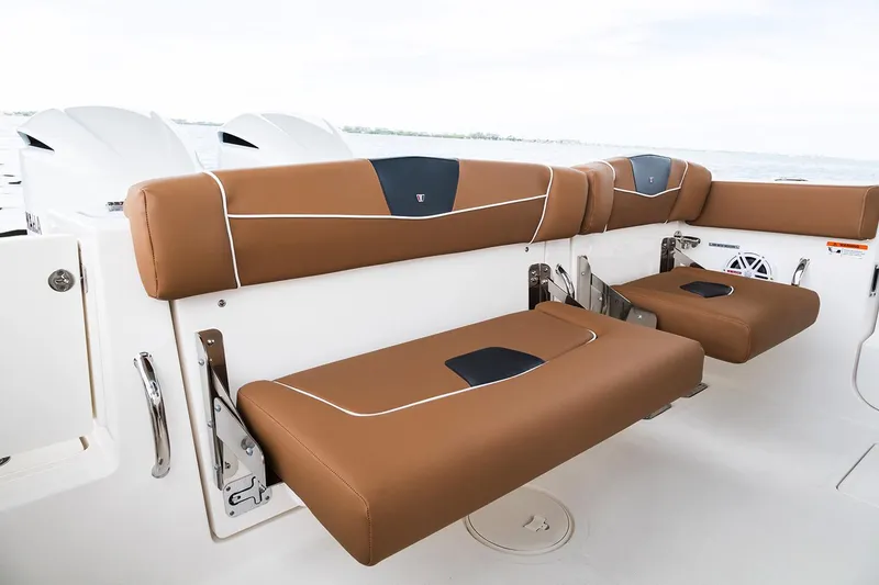 Slide: The Image of Manufacturer Provided Image: 2026 Wellcraft 302 Fisherman boat with brown cushioned seating, white interior, and ocean backdrop. - 11