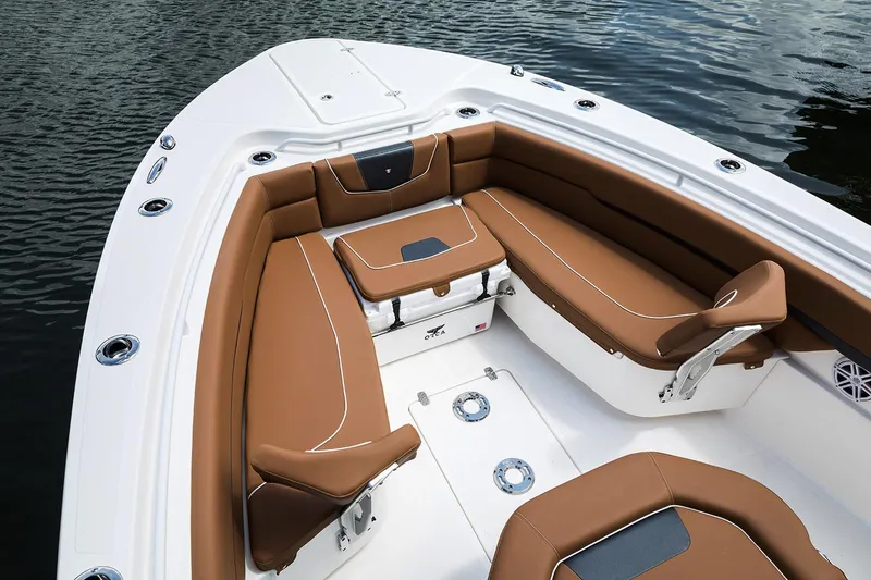 Slide: The Image of Manufacturer Provided Image: 2026 Wellcraft 302 Fisherman boat interior with brown seating, on calm water. - 3