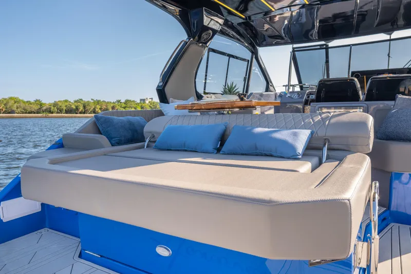 Slide: The Image of Luxurious 2026 Hanover 347 yacht interior with plush seating and scenic water view. - 11