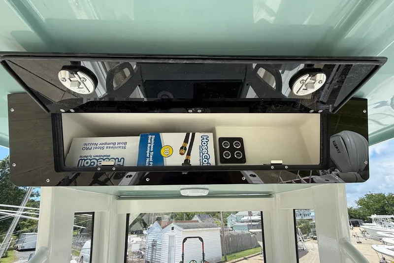 Slide: The Image of Interior view of a 2027 Key West 249 FS boat's storage compartment with equipment. - 15